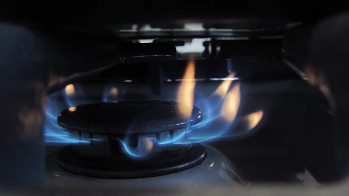 Blue flame on a gas stove burner, the kind of household use billed under the Atmos rate increase