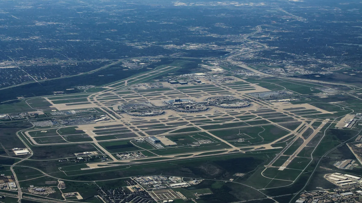 Aerial view of Dallas Fort Worth International Airport terminals and garages, where DFW Airport parking rates rose Oct. 1