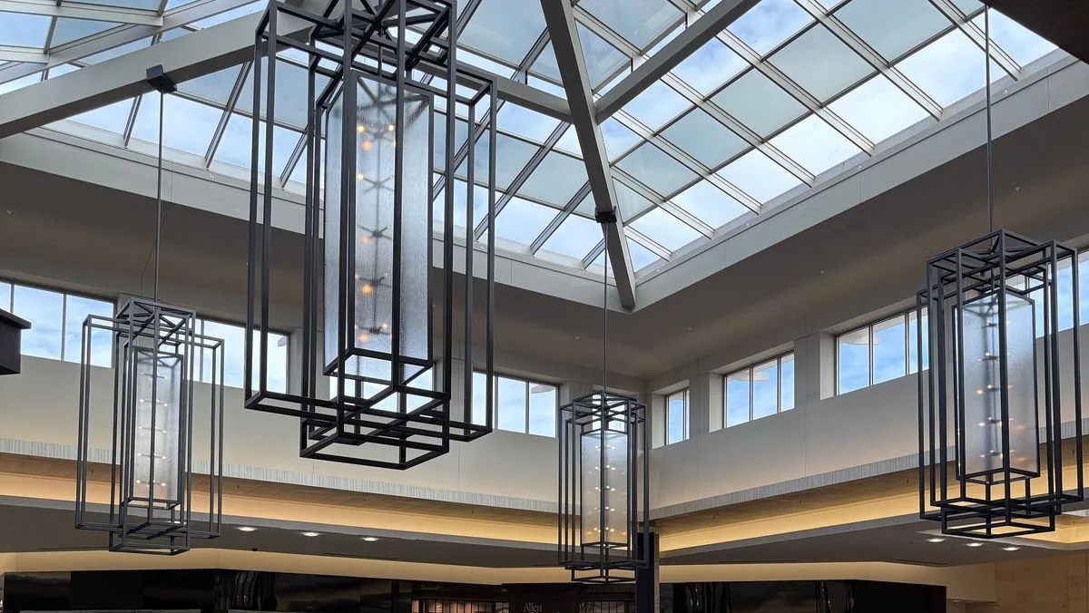 Skylit event court with hanging lanterns inside The Shops at Willow Bend, the area proposed for the Plano arena
