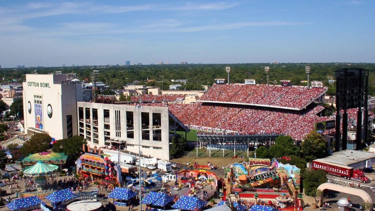 The Cotton Bowl packed with burnt orange and crimson fans during the 2006 Texas-Oklahoma game, seen above State Fair of Texas midway rides at Fair Park in Dallas